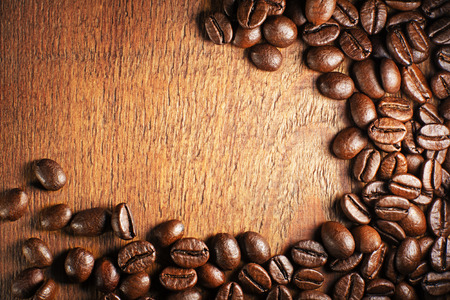 Coffee beans on a wooden background close upの写真素材