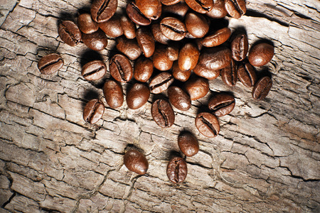 Coffee beans on a wooden background close upの写真素材