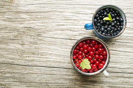 Blueberries and red currant on wooden backgroundの写真素材