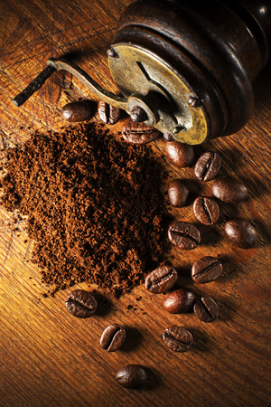 Fresh ground Coffee with hand grinder on wooden background.の写真素材