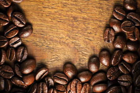 Coffee beans on wooden table close upの写真素材