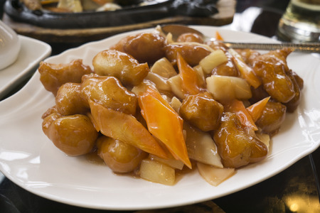 Sweet and sour chicken with vegetable on a plateの写真素材