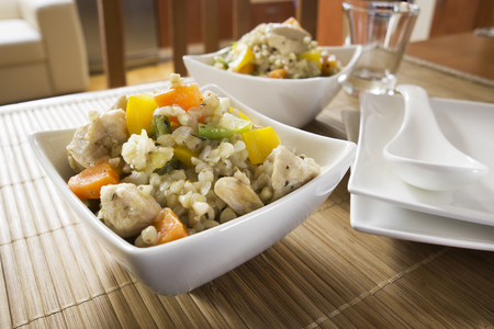 Risotto with vegetable, meat, fresh herbs and parmesan cheese.の写真素材