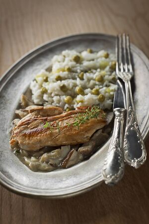 Roasted meat with mushroom sauce and rice with peaの写真素材