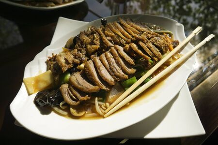 Roasted duck with vegetables on plate. Chinese style, chinese foodの写真素材