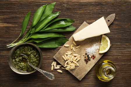 Wild garlic pesto ingredients on wooden backgroundの写真素材