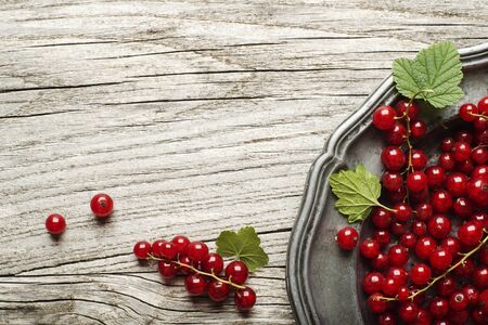 Fresh redcurrant on wooden background close upの写真素材