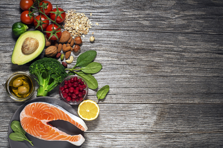 Mixed fresh healthy food on wooden background - heart conceptの写真素材