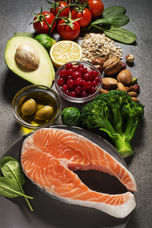Mixed fresh healthy food on dark background - heart conceptの写真素材