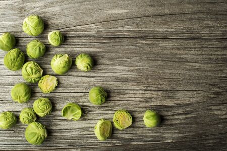 Fresh raw brussels sprouts on a wooden backgroundの写真素材