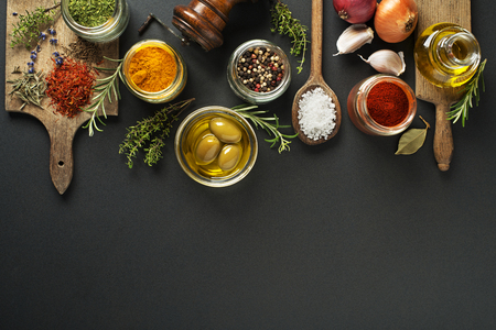 Fresh herbs and spices on a black backgroundの写真素材