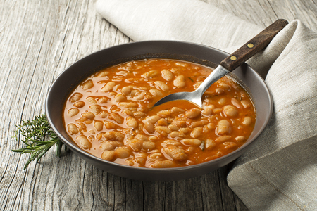 White bean stew with fresh spices on wooden tableの写真素材