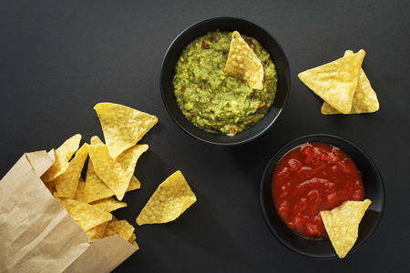 Guacamole and tomato salsa with corn nachos chipsの写真素材