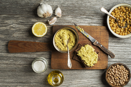 Classic hummus chickpeas with bread on wooden backgroundの写真素材