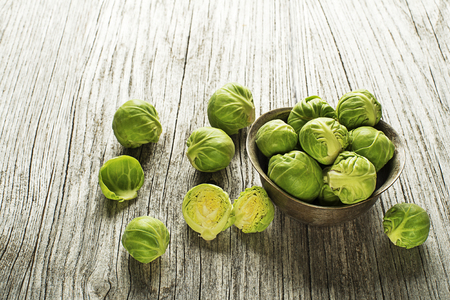 Fresh raw brussels sprouts on a wooden backgroundの写真素材