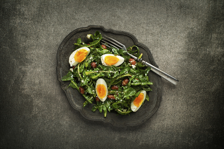 Fresh dandelion salad with eggs and beans overhead shootの写真素材