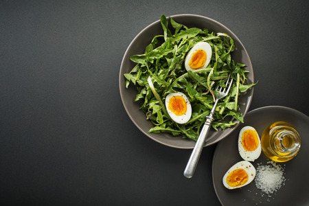 Fresh healthy dandelion salad with eggs overhead shootの写真素材