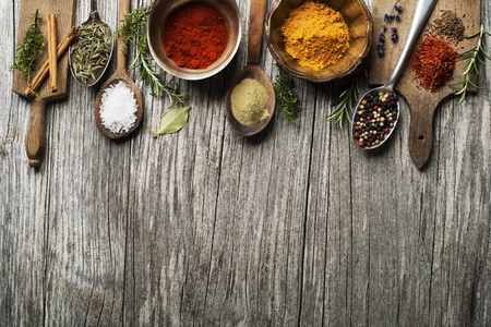 Fresh herbs and spices on a wooden backgroundの写真素材