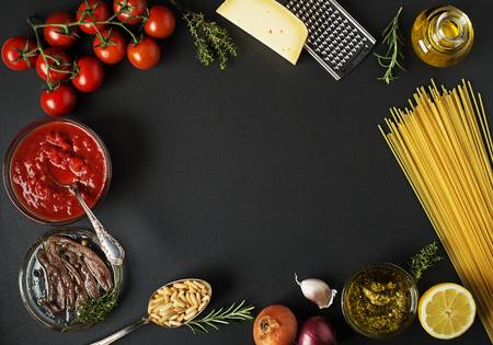 Fresh ingredients for cooking pasta on black background place for text. Vegan food vegetarian and healthy cooking concept.の写真素材