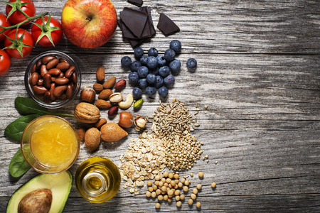 Selection of healthy food on wooden background. Healthy diet foods for heart cholesterol and diabetesの写真素材