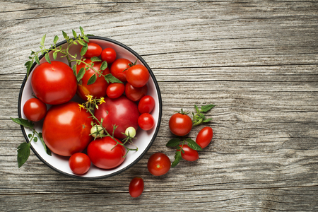 Fresh tomatoes on wooden background. Top viewの写真素材