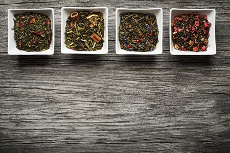 Dry tea collection of different types on wooden backgroundの写真素材