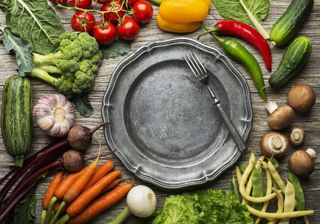 Various of fresh vegetables and ingredients with plate on wooden background. Healthy diet food conceptの写真素材