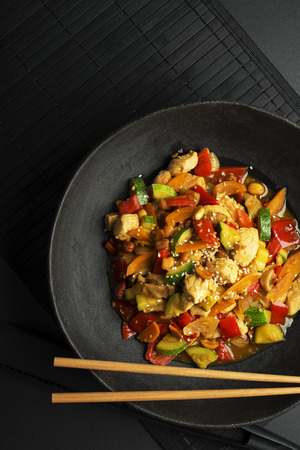 Chinese food with meat and vegetables on black backgroundの写真素材