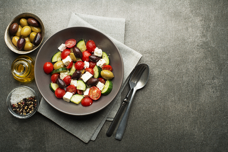 Salad with cheese and fresh vegetables on gray background. Greek salad.の写真素材