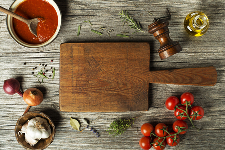 Fresh ingredients for cooking tomato sauce or soup on wooden background place for text. Vegan food vegetarian and healthy cooking concept.の写真素材