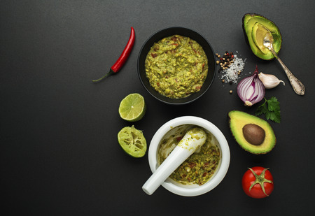 Fresh ingredients with avocado for guacamole sauce on black backgroundの写真素材
