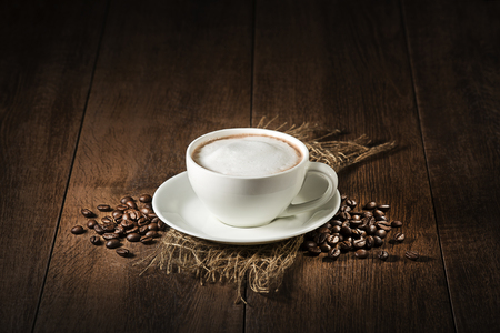 Coffee cup of cappuccino on wooden rustic backgroundの写真素材
