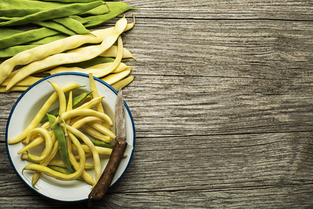 Fresh green and yellow beans on wooden tableの写真素材