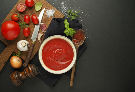 Fresh ingredients for cooking tomato sauce or soup on wooden background place for text. Vegan food vegetarian and healthy cooking concept.の写真素材