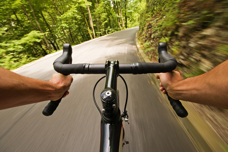 Cyclist riding a bike on the road in natureの写真素材