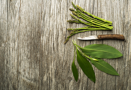 Spring food wild garlic and asparagus on wooden backgroundの写真素材