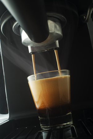 Espresso pouring from coffee machine. Professional coffee brewingの写真素材