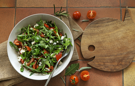 Rocket Salad with arugola tomato and cheese on background.の写真素材