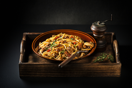 Delicious spaghetti with bolognese sauce served on black backgroundの写真素材