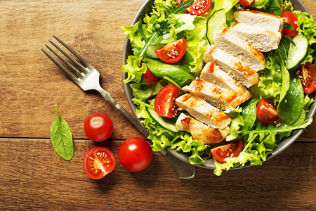 Fresh green salad with chicken breast and tomato. Top viewの写真素材