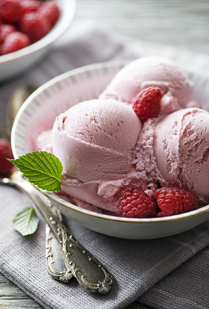 Homemade organic Raspberry ice cream scoops in bowlの写真素材