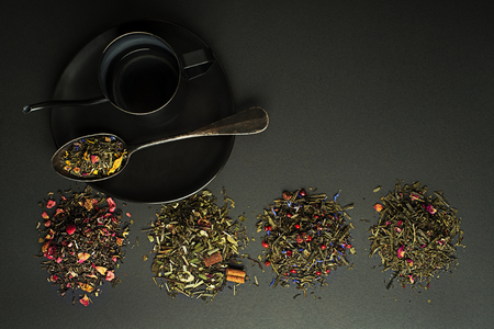 Dry tea and herbs collection of different types on black tableの写真素材