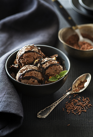 Homemade Organic chocolate Ice Cream scoop decorated with chocolate sauceの写真素材