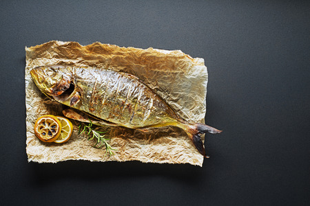 Grilled Gilt-head bream fish with herbs and spicesの写真素材