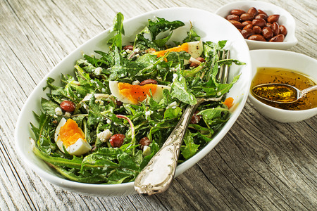 Fresh healthy dandelion salad with eggsの写真素材