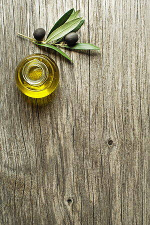 Bottle of Extra virgin healthy Olive oil with fresh olives close upの写真素材