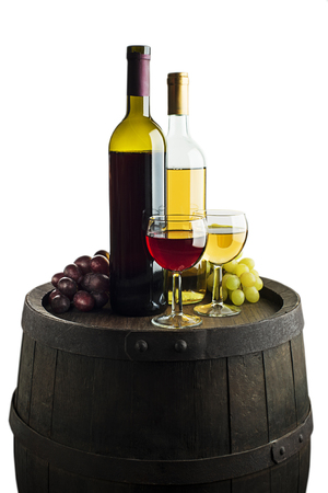 Glass and bottle of red wine and white wine on wooden barrel backgroundの写真素材