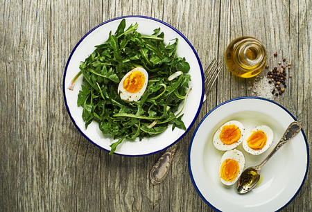 Fresh healthy dandelion salad with eggs overhead shootの写真素材