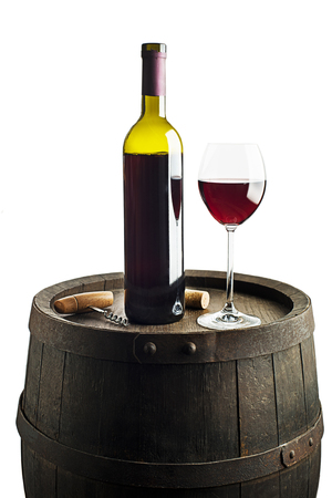 Glass and bottle of red wine on wooden barrel backgroundの写真素材