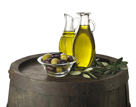 Bottle of Extra virgin healthy Olive oil on wooden barrel background isolated on whiteの写真素材
